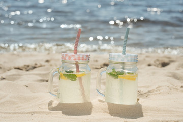 Two mojitos on the beach in the sand