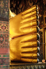 Feet of the golden reclining Buddha statue at the Wat Pho Temple, Bangkok, Thailand