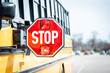 School bus stop sign with flashing lights