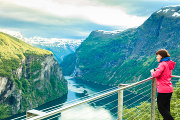 Poster - Tourist looking at Geirangerfjord from Flydasjuvet viewpoint Norway