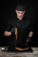 Chocolatier In Black Uniform In The Process Of Making Chocolates