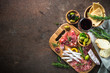 Antipasto - sliced meat, ham, salami, olives and glass wine