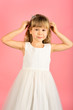 © Volodymyr - Child girl in stylish glamour dress, elegance. Fashion and beauty, little princess. Fashion model on pink background, beauty. Little girl in fashionable dress, prom. Look, hairdresser, makeup.