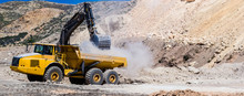 Wheel Loader Excavator Unloading Sand With Water During Earth Moving Works At Construction Site