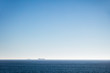 © StudioWout - Distant cargo ships on the ocean horizon