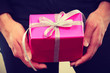 © anetlanda - pink gift box in male hands