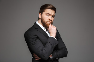 Wall Mural - Portrait of a pensive young businessman dressed in suit