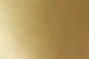 Gold or Bronze Natural Leather Background. Shiny yellow leaf gold foil texture background. Place for Text