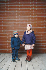 Wall Mural - Boy and Girl at Brick Wall