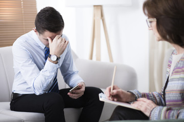 Wall Mural - Depressed man at psychotherapy