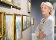 © JackF - Female visitor looking at artwork painting in the museum indoors