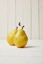 Two Yellow Organic Pears On Wooden Background