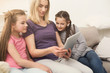 © Prostock-studio - Beautiful young woman and her daughters using digital tablet