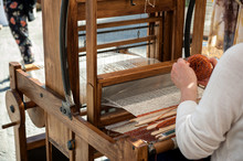 Close Up Hands Of Woman Weaving Color Pattern On Traditional Hand-weaving Wooden Loom