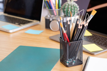 pencil in jar on workspace table in office.