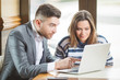 © bokan - Business couple in cafe working and using laptop