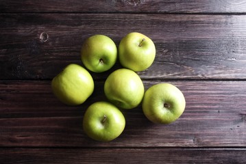 Wall Mural - Green apples on a wood board