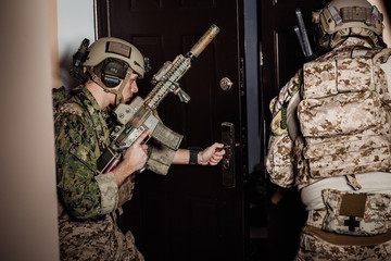 soldiers or private military contractors holding rifle. Image on a black background. war, army, weapon, technology and people concept