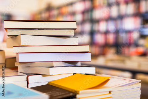different books lying on table in library Poster Mural XXL
