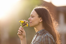 Pretty Woman Smelling Flowers
