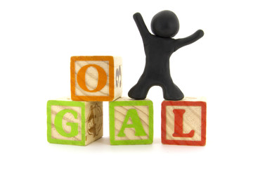 Black plasticine character and wooden cubes. Goal achievement. Alphabet blocks. Isolated on white background