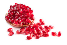 Piece Of Pomegranate And Heap Of Seeds Isolated On White Background