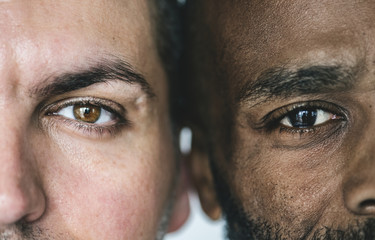 two different ethnic men's eyes closeup