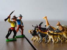 Hunters Against Wild Animals. Miniature Plastic Figures. Soft Focus Effect.