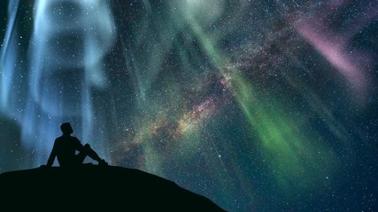 Wall Mural - The man sitting against the starry sky with a northern light. time lapse