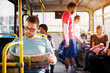 © dusanpetkovic1 - Young man is focused on reading his newspapers while taking a bus ride.