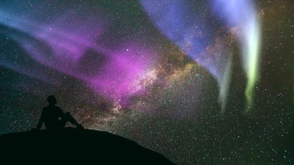 Wall Mural - The man sitting against the meteor shower with a northern light. time lapse