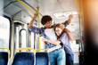 © dusanpetkovic1 - Young gorgeous playful girl is hugging her cheerful and surprised boyfriend in a bus.