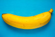 yellow banana on a blue paper background