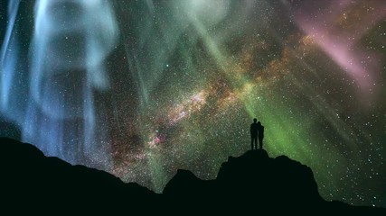 Wall Mural - The couple standing on the rock against a starry sky with a northern light