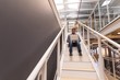 © Wavebreak Media - Businessman using laptop on staircase