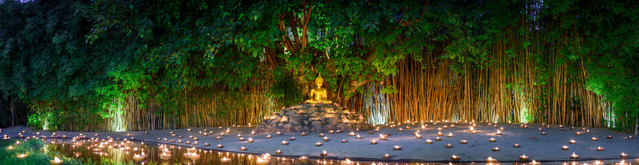 monks sitting meditate with many candle in Thai temple at night , Chiangmai ,Thailand,