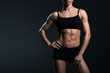 © LIGHTFIELD STUDIOS - cropped view of female bodybuilder standing sportswear,  isolated on grey