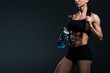 © LIGHTFIELD STUDIOS - cropped view of muscular sportswoman with water in sport bottle, isolated on grey