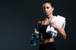 © LIGHTFIELD STUDIOS - attractive sportswoman with water and towel after training, isolated on grey