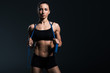 © LIGHTFIELD STUDIOS - beautiful sportswoman with jump rope for cardio training, isolated on grey