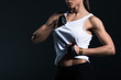 © LIGHTFIELD STUDIOS - cropped view of muscular sportswoman showing abs, isolated on black