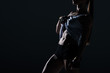© LIGHTFIELD STUDIOS - silhouette of muscular sportswoman showing abs, isolated on black