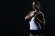 © LIGHTFIELD STUDIOS - beautiful female bodybuilder posing in sportswear, isolated on black