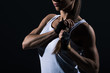 © LIGHTFIELD STUDIOS - cropped view of muscular sportswoman posing in sportswear, isolated on black