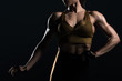 © LIGHTFIELD STUDIOS - cropped view of female bodybuilder posing and showing muscles, isolated on black