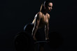 © LIGHTFIELD STUDIOS - beautiful female bodybuilder lifting barbell, isolated on black