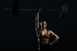 © LIGHTFIELD STUDIOS - attractive strong bodybuilder holding barbell, isolated on black