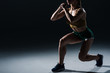 © LIGHTFIELD STUDIOS - cropped view of sporty female bodybuilder doing lunges, on black