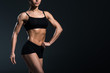 © LIGHTFIELD STUDIOS - cropped view of sexy female bodybuilder with sexy muscular body,  isolated on grey