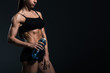 © LIGHTFIELD STUDIOS - cropped view of muscular bodybuilder in sportswear with sport bottle, isolated on grey